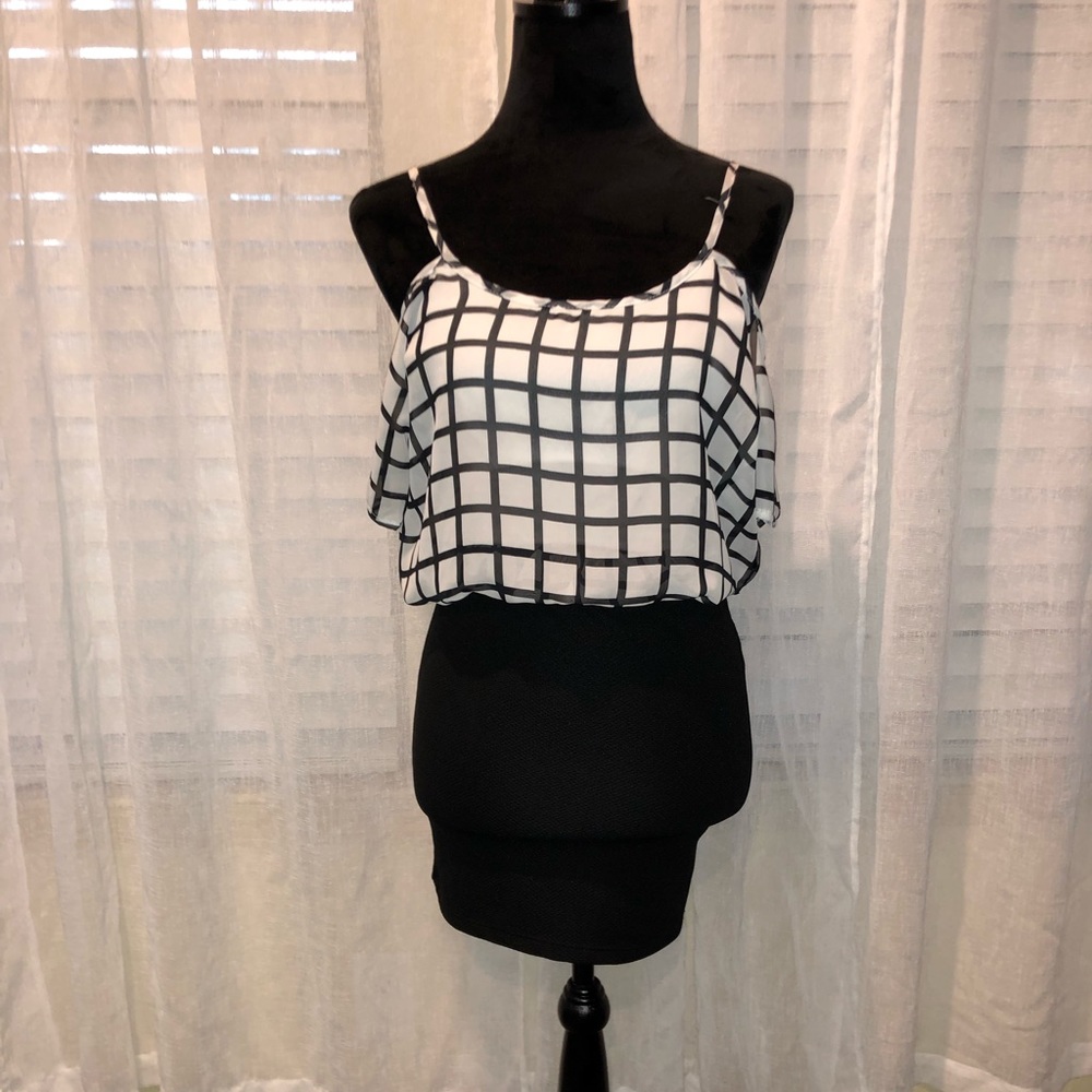 Mini dress with flowy top and tight bottom.